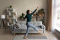 Overjoyed happy millennial hispanic woman dance at modern living room Royalty Free Stock Photo