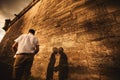 A wonderful love story. Young couple walking around the old wall of castle Royalty Free Stock Photo