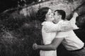 A wonderful love story. Young couple walking around the old wall of castle. Black and white Royalty Free Stock Photo