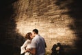 A wonderful love story. Young couple walking around the old wall of castle. Black and white Royalty Free Stock Photo