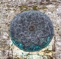 Wonderful Medieval Pattern on Circular Manhole Cover in old town, Gruyere, Fribourg, Switzerland, Europe