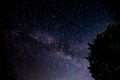 Wonderful Milky Way Galaxy is shining in Night Sky and it looks blue and nebula. Also There is a Tree Silhouette, Germany, Europe