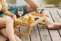 Wonderful moments of relaxation on summer picnic with wine, fruit and complete relaxation barefoot on heated wooden terrace. Rest Royalty Free Stock Photo