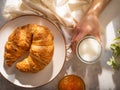 Wonderful morning breakfast with croissants, jam and milk. Beautiful white dishes. Pastel background. Bright lighting. High angle