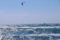 Wonderful morning day, ideal time for some activity. In the distance Kiteboarder sails on surfboard and gaining speed thanks to
