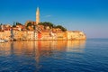 Wonderful morning view of old Rovinj town with multicolored buildings and yachts moored along embankment, Croatia