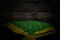 wonderful national holiday flag 3d illustration - dark image of Jamaica flag with large folds on old wood with free space for