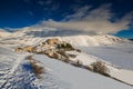 Wonderful and panoramic view of Castelluccio di Norcia village with snow in the winter season, Umbria