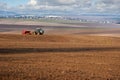 panoramic view of land, tractor with seeder, sowing time in spring