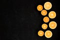 A black plywood background in composition with cut in halves oranges and tangerines placed in semicircle Royalty Free Stock Photo