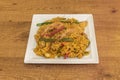 Wonderful platter of Spanish seafood and fish paella with roasted red and green peppers in strips with many prawns on a white Royalty Free Stock Photo