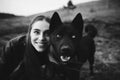 A wonderful portrait of a girl and her dog with colorful eyes. Black and white photo