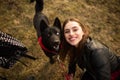 A wonderful portrait of a girl and her dog with colorful eyes. Friends are posing on the shore of the lake