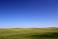 Wonderful prairie background - beautiful grass hills and a clear blue sky Royalty Free Stock Photo