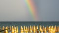 Wonderful rainbow over the Adriatic sea. Contrast between the bright colors of the rainbow and the green sea