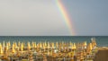 Wonderful rainbow over the Adriatic sea. Contrast between the bright colors of the rainbow and the green sea