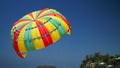 Wonderful red green and yellow parachute under blue sky Royalty Free Stock Photo