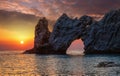 Wonderful rock with a hole on the sea at sunset