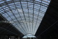 Wonderful roof of railway station in London. Roof has part of top is glass and part is hidden in the dark. Travelers can see sky Royalty Free Stock Photo