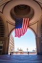Wonderful shot of waving american flag with the sun behind in a hall in Boston
