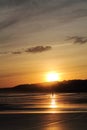 Wonderful silhouette of man and dog walking on sandy beach in colorful sunrise summer sky with reflection Royalty Free Stock Photo