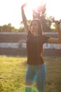 Wonderful sporty woman stretching before workout at the stadium.