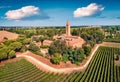 Wonderful summer view of Pomposa Abbey tower among the green vineyards. Royalty Free Stock Photo