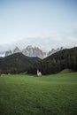 Sunny Landscape of Dolomite Alps with St Johann Church and mountains in the background Royalty Free Stock Photo