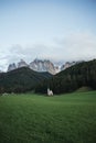 Sunny Landscape of Dolomite Alps with St Johann Church and mountains in the background Royalty Free Stock Photo