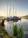 A wonderful sunrise over Lake Baldeneysee in the city of Essen. Moored sailboats in the foreground. Landscape photography