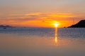 Wonderful sunset landscape on the seashore, colors of the sunset sky and silhouette of island in the water. incredible tropical