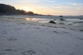 Wonderful sunset on a lonely beach at low tide, single boat on the sand, peaceful mood Royalty Free Stock Photo