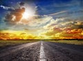 A wonderful sunset and a paved road Royalty Free Stock Photo