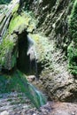 Wonderful tranquil waterfall falling from rocks overgrown with moss