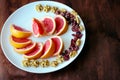 Wonderful vegan food: grapefruit sliced with slices, walnut kernels, dried cranberries stand on a white plate