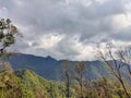 Wonderful view of big fluffy cloud over top of mountain. Royalty Free Stock Photo