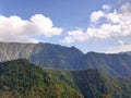 Wonderful view of big fluffy cloud over top of mountain. Royalty Free Stock Photo