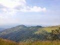 Wonderful view of big fluffy cloud over top of mountain. Royalty Free Stock Photo