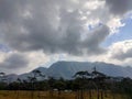 Wonderful view of big fluffy cloud over top of mo Royalty Free Stock Photo