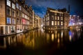 Amsterdam canals and houses against night cityscape of Amsterdam, Holland Netherlands Royalty Free Stock Photo