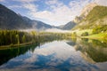 Wonderful view of Lake Hintersee with trees and clouds reflecting on its surface, Ramsau, Germany