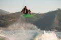 Wonderful view of man with wakeboard jumping in the air over splashing water Royalty Free Stock Photo