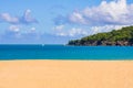 Wonderful view over the golden beach over the blue sea to white boats on the horizon and a green spit of land, white clouds Royalty Free Stock Photo