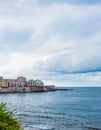 Wonderful view of the seafront of Ortigia in Syracuse on a summer day, with blue sea and cloudy sky as a backdrop