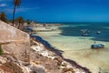 Wonderful views of the Mediterranean coast with birch water, white sand beach and a fishing boat.