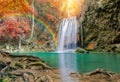 Wonderful Waterfall with rainbows and red leaf in Deep forest