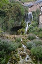 Wonderful Waterfalls With Silk Effect Of A Crystalline Greenish Water Running Between The Houses And Flowing In The Ebro River In