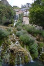 Wonderful Waterfalls With Silk Effect Of A Crystalline Greenish Water Running Between The Houses And Flowing In The Ebro River In