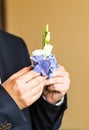 Wonderful wedding boutonniere on a costume of groom close-up