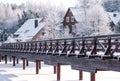 Wonderful white winter landscape with frozen lake, wooden houses and bridge Royalty Free Stock Photo